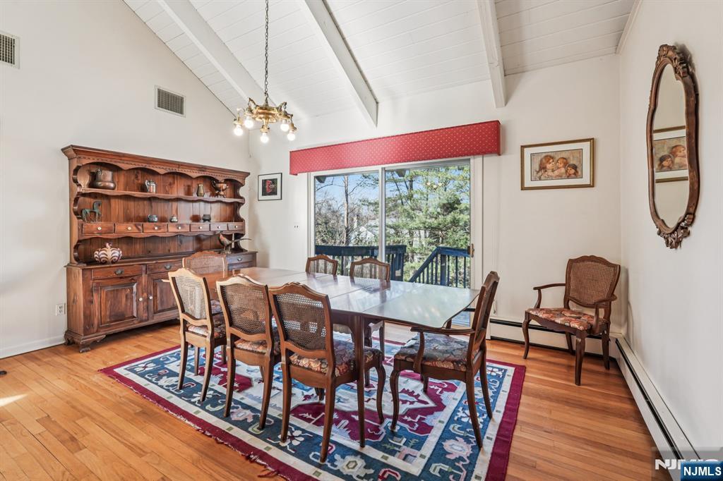 873 Olentangy Road Franklin Lakes, NJ 07417 - Photo 9 of 41 a view of a dining room with furniture a chandelier and wooden floor