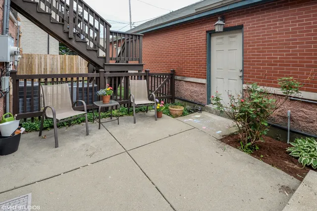 a view of patio with chairs and potted plants