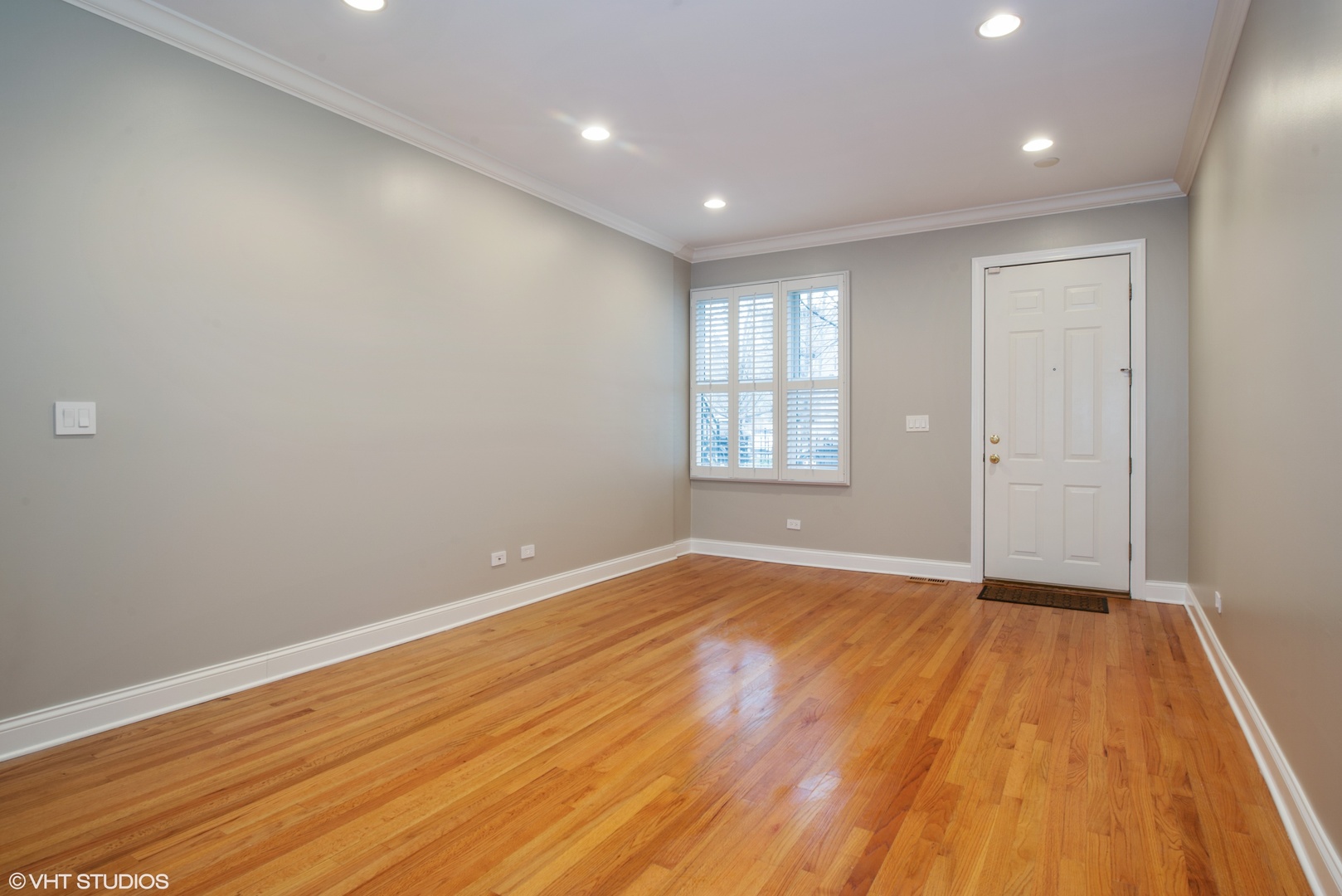 1437 West Fillmore Street Chicago, IL 60607 - Photo 15 of 23 a view of an empty room with wooden floor and a window