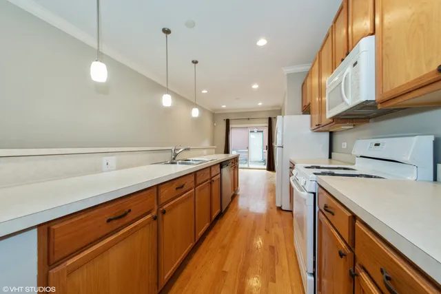 a large kitchen with stainless steel appliances granite countertop a lot of counter space and a sink