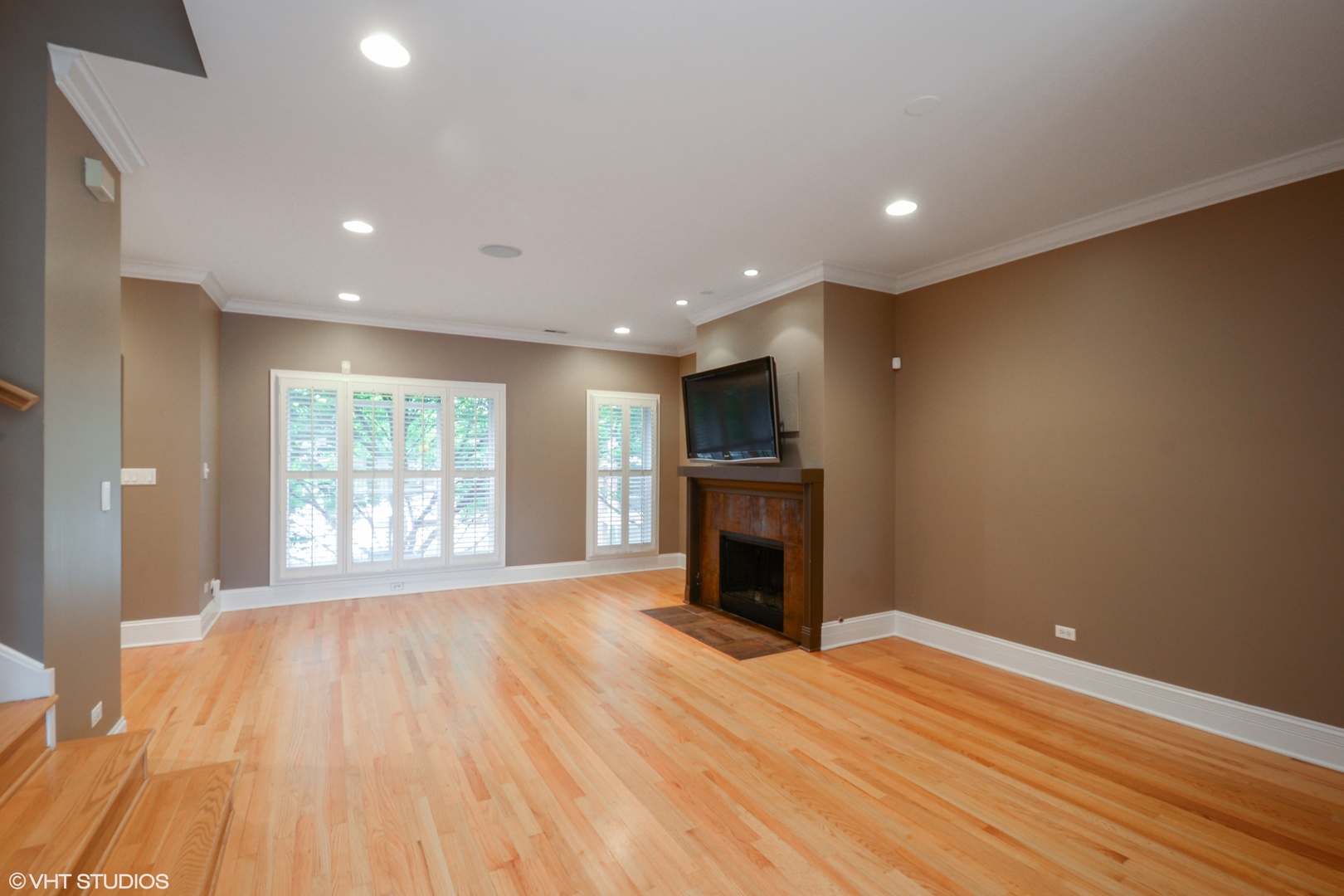 1437 West Fillmore Street Chicago, IL 60607 - Photo 2 of 23 a view of empty room with wooden floor and fireplace