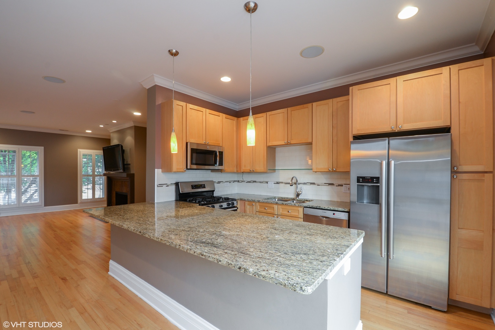 1437 West Fillmore Street Chicago, IL 60607 - Photo 5 of 23 a kitchen with stainless steel appliances granite countertop sink refrigerator and microwave