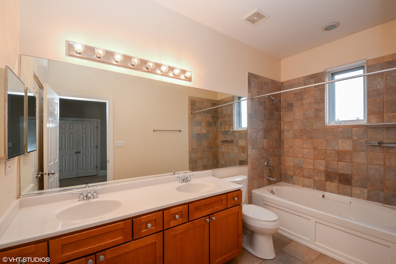 1437 West Fillmore Street Chicago, IL 60607 - Photo 9 of 23 a bathroom with a granite countertop sink a toilet and bathtub