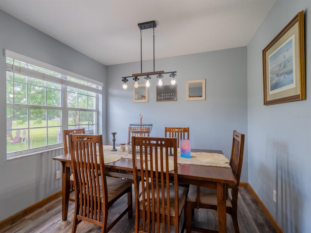 4381 Northeast 105th Place Anthony, FL 32617 - Photo 11 of 49 a view of a dining room with furniture window and wooden floor