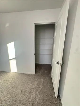 an empty room with a wooden door