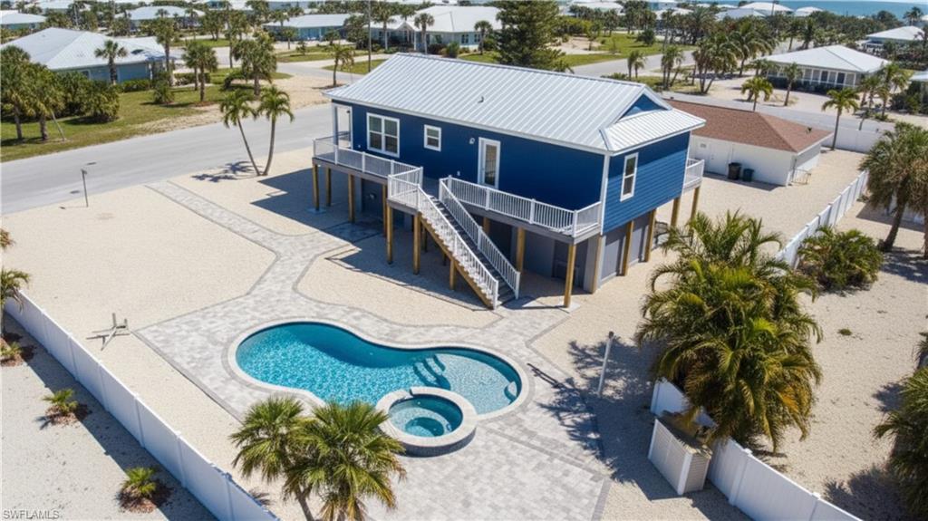 1 Fairview Boulevard Fort Myers Beach, FL 33931 - Photo 42 of 48 Virtually EDITED Groundscaping - Back of house featuring a patio area, a fenced backyard, a metal roof, stairs, and a pool & spa-VIRTUALLY EDITED