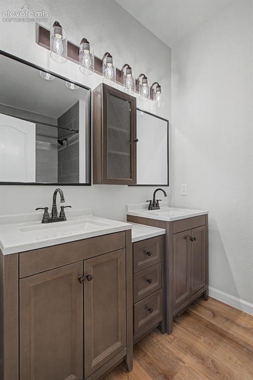 5353 Palomino Ranch Point, Unit 307 Colorado Springs, CO 80922 - Photo 26 of 30 Adjoining Primary Bathroom with new dual vanities and integrated sinks with dark bronze fixtures