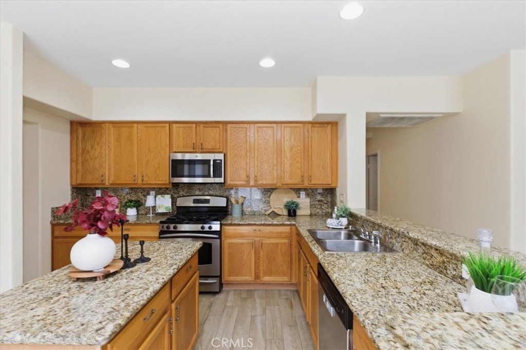 39264 Memory Drive Murrieta, CA 92563 - Photo 12 of 35 a kitchen with a sink stove and microwave