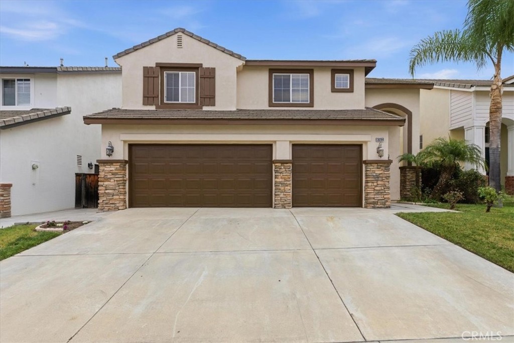 39264 Memory Drive Murrieta, CA 92563 - Photo 2 of 35 a front view of a house with a yard and garage