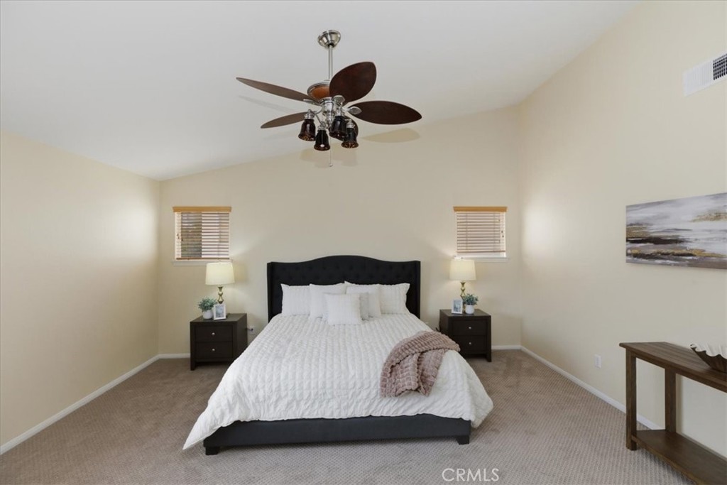 39264 Memory Drive Murrieta, CA 92563 - Photo 25 of 35 a bedroom with a bed and a chandelier