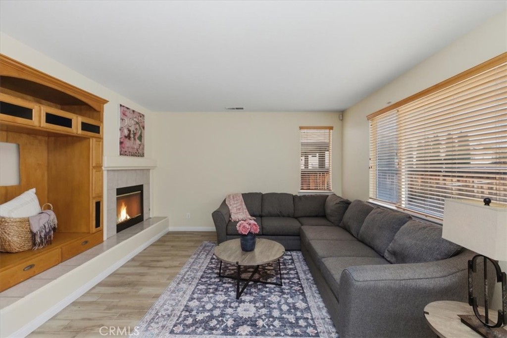 39264 Memory Drive Murrieta, CA 92563 - Photo 9 of 35 a living room with furniture a fireplace and a window