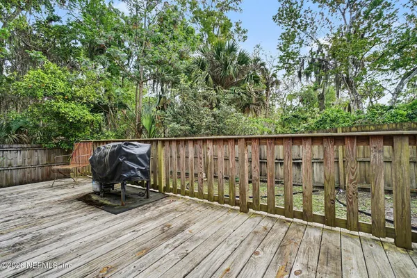 a view of outdoor space with wooden floor and bench