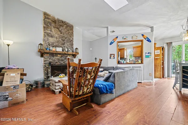 a living room with furniture a fireplace and a large window