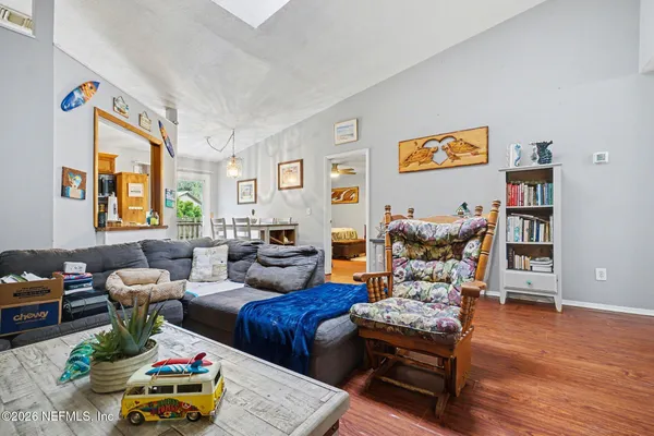 a living room with furniture and a wooden floor