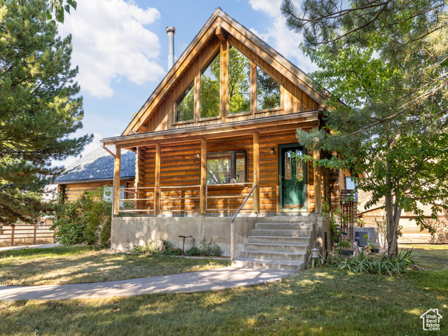 4676 Droubay Road Erda, UT 84074 - Photo 1 of 1 Log-style house with porch.