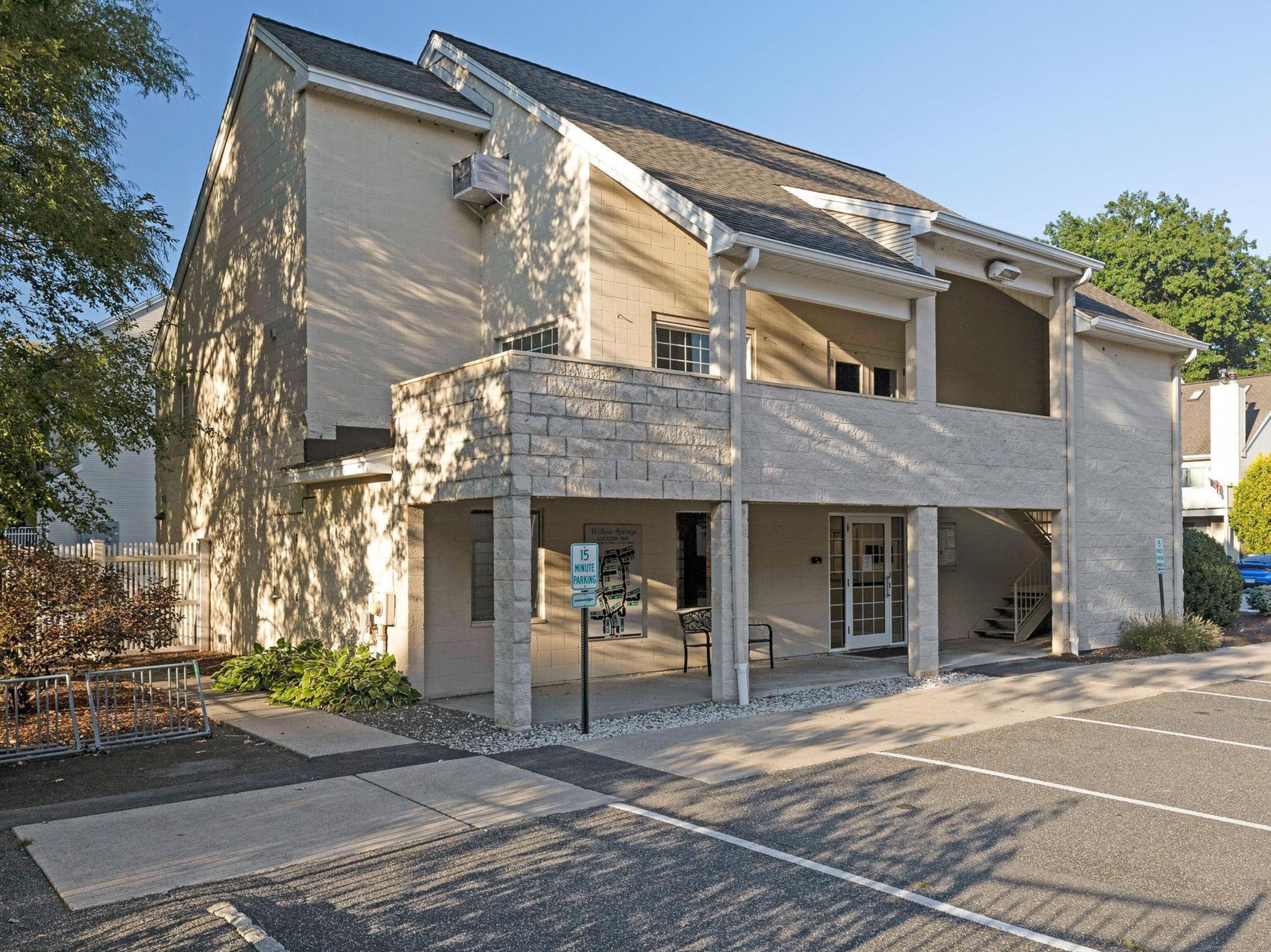 52 Willow Springs, Unit 52 New Milford, CT 06776 - Photo 11 of 14 a front view of a building with a garden