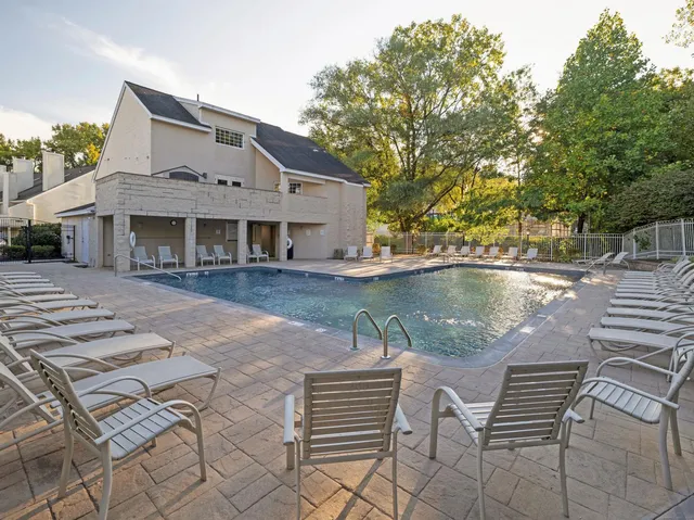 a view of house with yard and sitting area