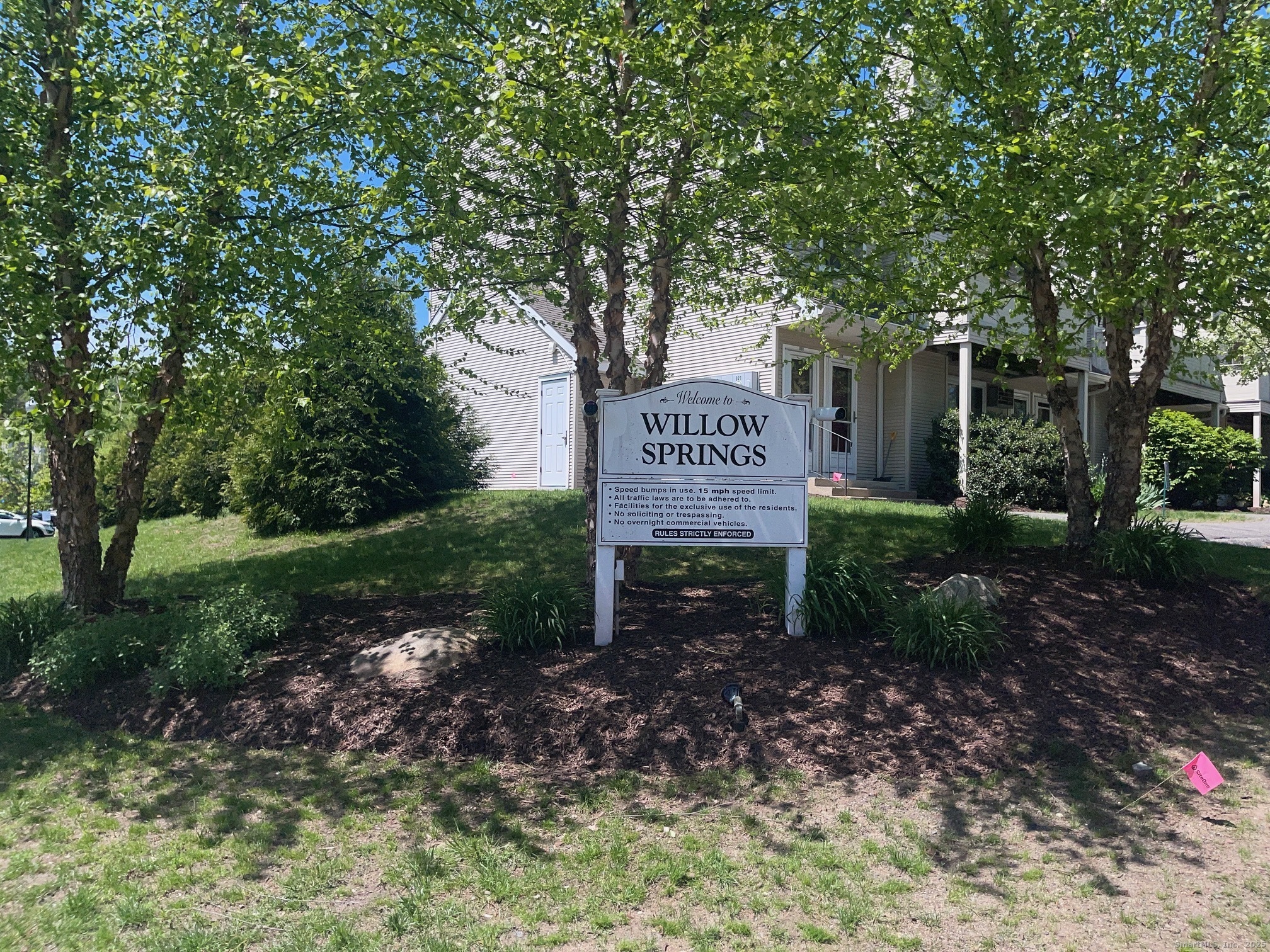 52 Willow Springs, Unit 52 New Milford, CT 06776 - Photo 14 of 14 a sign that is sitting in front of a tree