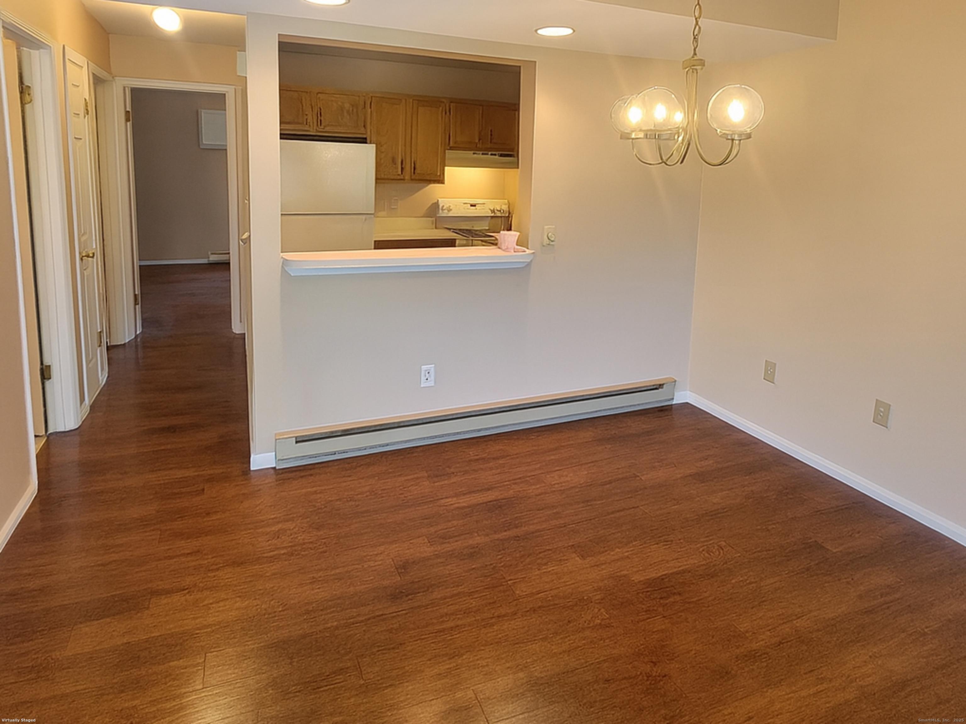52 Willow Springs, Unit 52 New Milford, CT 06776 - Photo 3 of 14 a view of a room with wooden floor and staircase