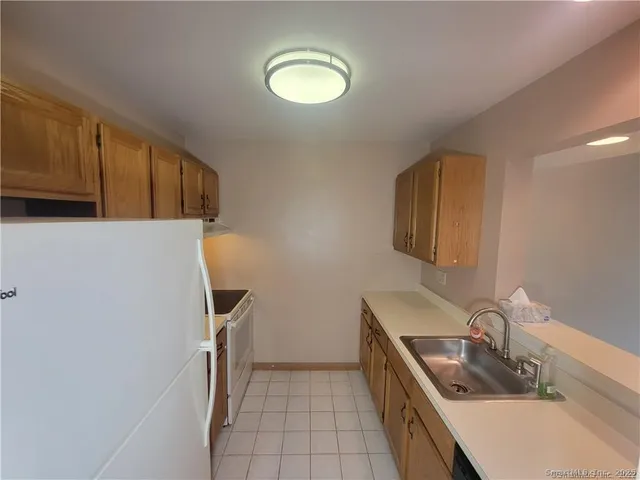 a kitchen with a refrigerator and a sink