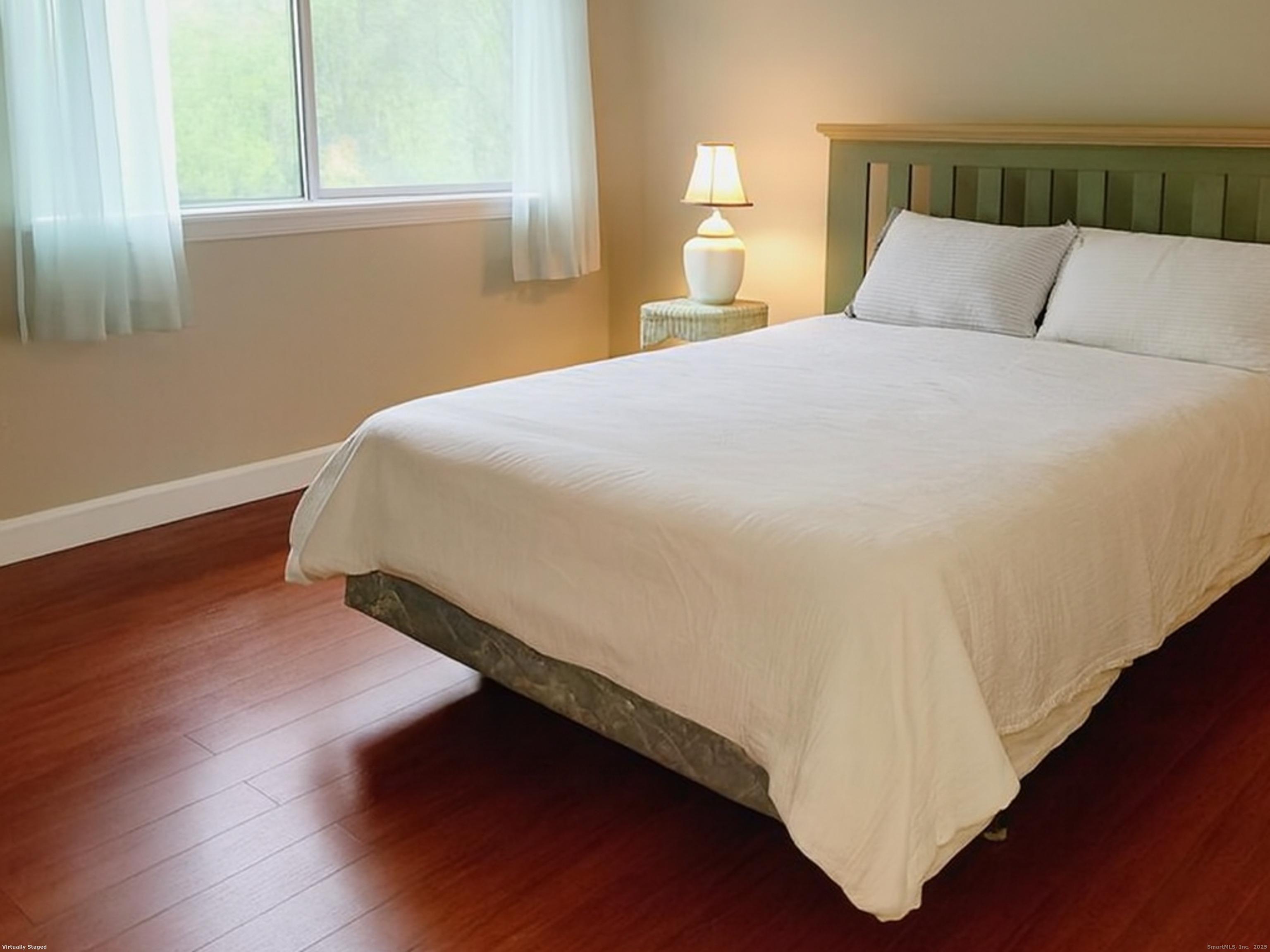 52 Willow Springs, Unit 52 New Milford, CT 06776 - Photo 6 of 14 a bed sitting in a bedroom next to a window