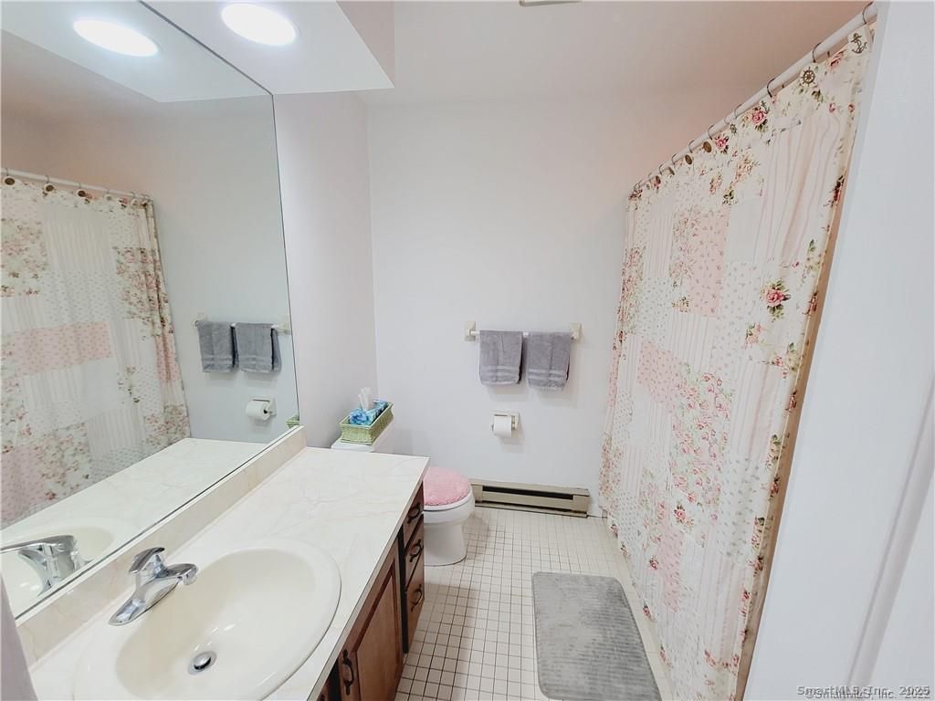 52 Willow Springs, Unit 52 New Milford, CT 06776 - Photo 8 of 14 a bathroom with a sink and a mirror