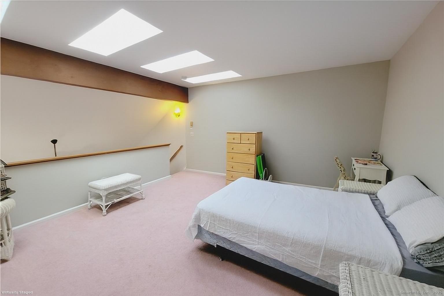 52 Willow Springs, Unit 52 New Milford, CT 06776 - Photo 9 of 14 a bedroom with a bed and wooden floor