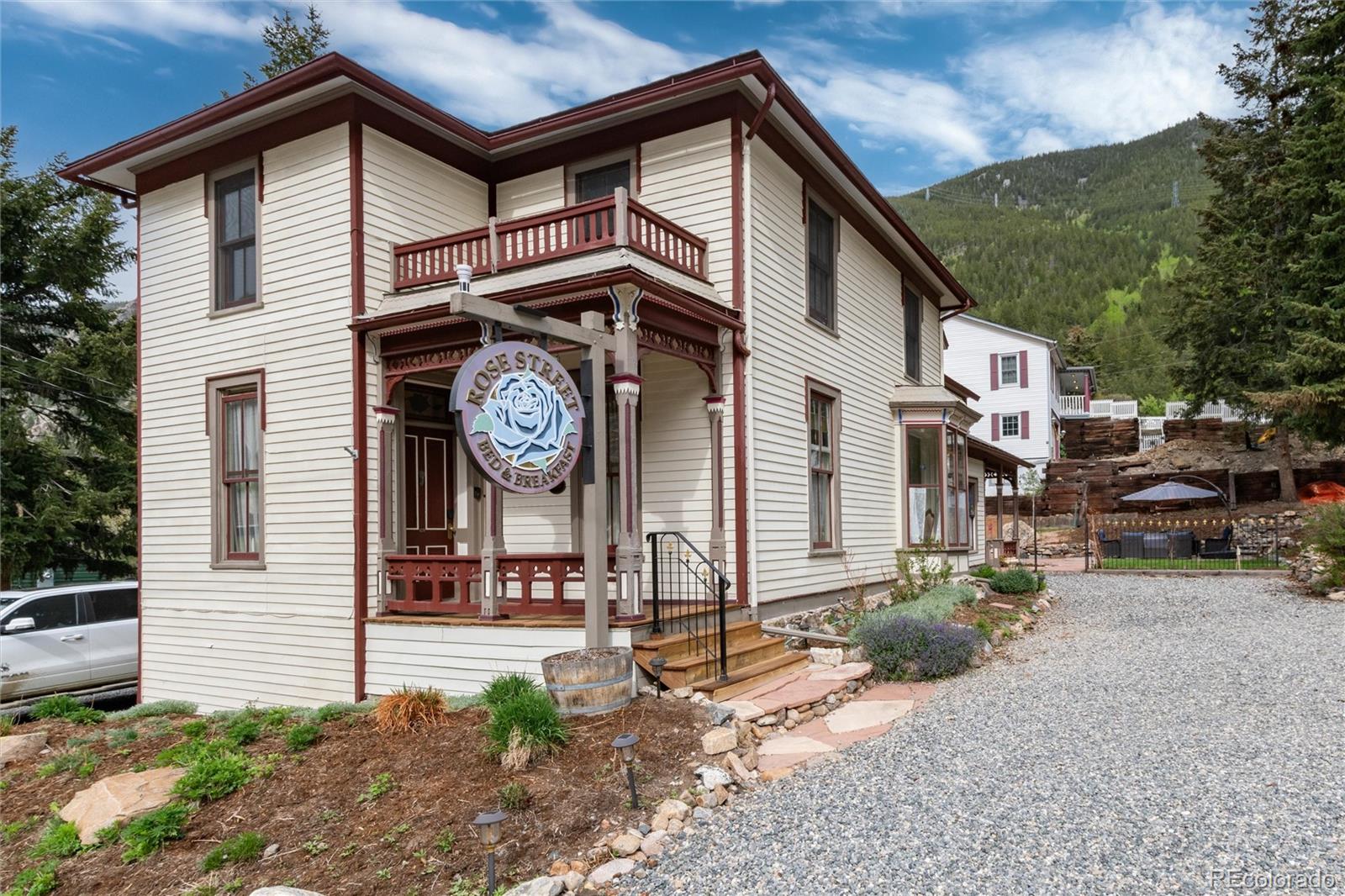 a view of a house with a large space and a large tree