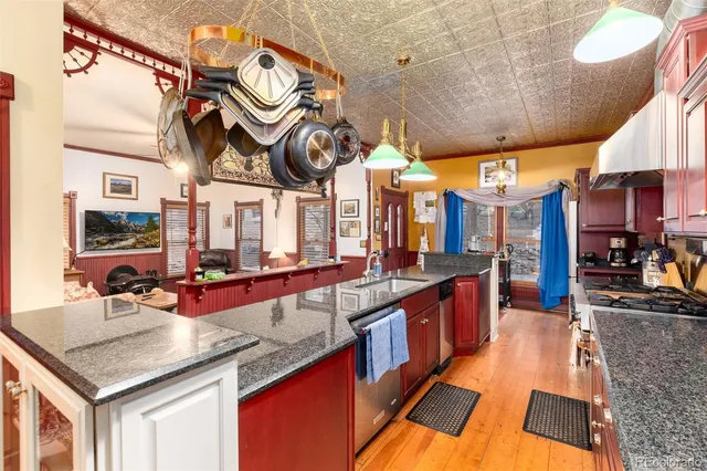 a large kitchen with stainless steel appliances granite countertop a sink and cabinets