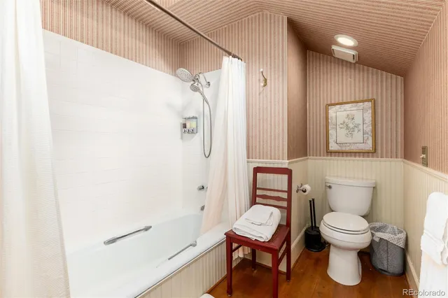 a white toilet sitting next to a bathroom sink