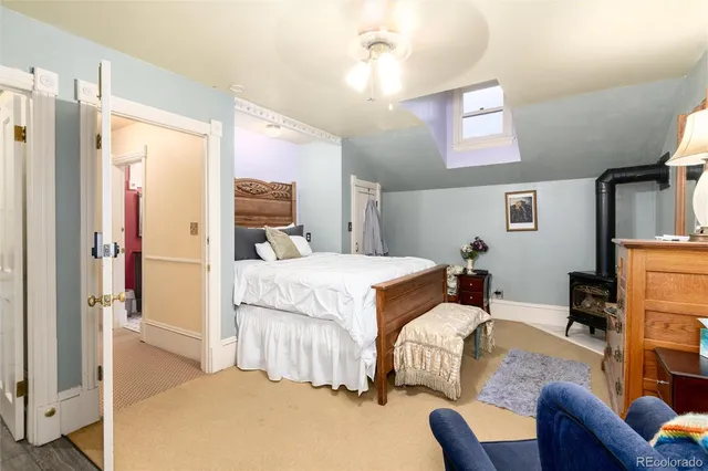 a bedroom with a bed couch and a window