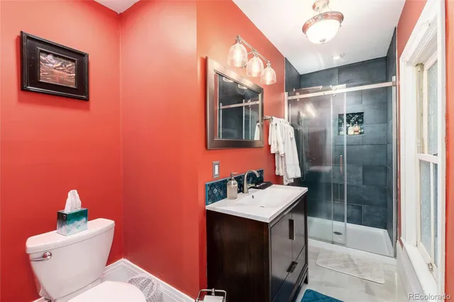 a bathroom with a sink mirror toilet and shower