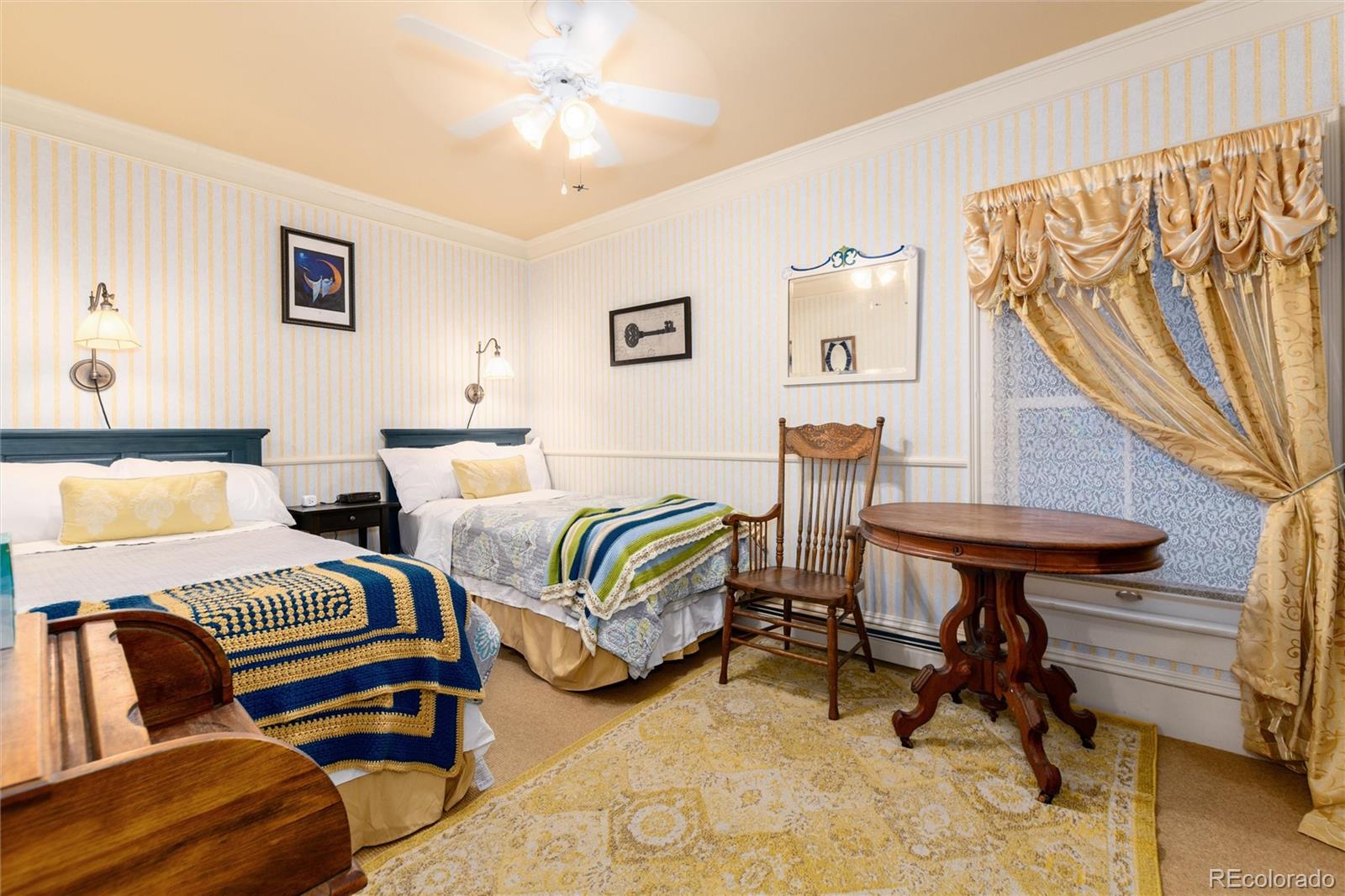 200 Rose Street Georgetown, CO 80444 - Photo 24 of 43 a bedroom with two beds and a chandelier