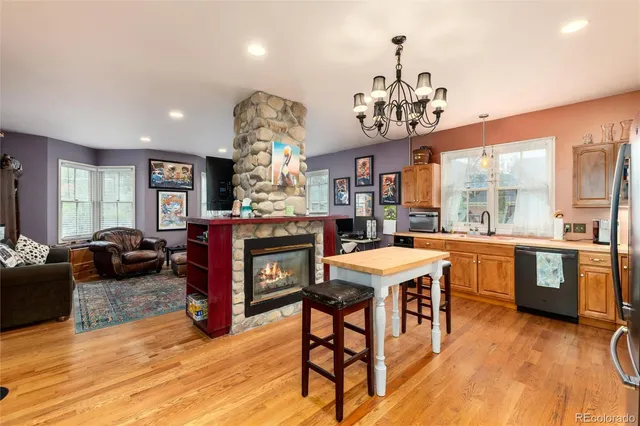 a kitchen with stainless steel appliances granite countertop a kitchen island a stove and a sink