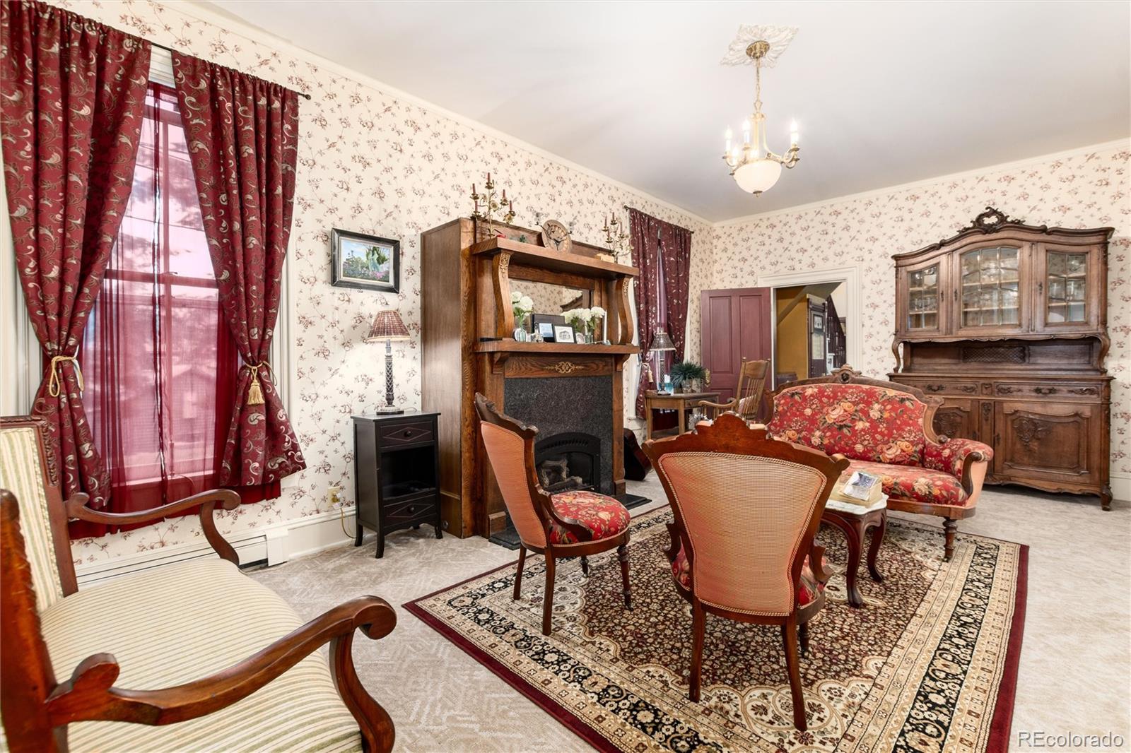 200 Rose Street Georgetown, CO 80444 - Photo 3 of 43 a living room with furniture a fireplace and a flat screen tv