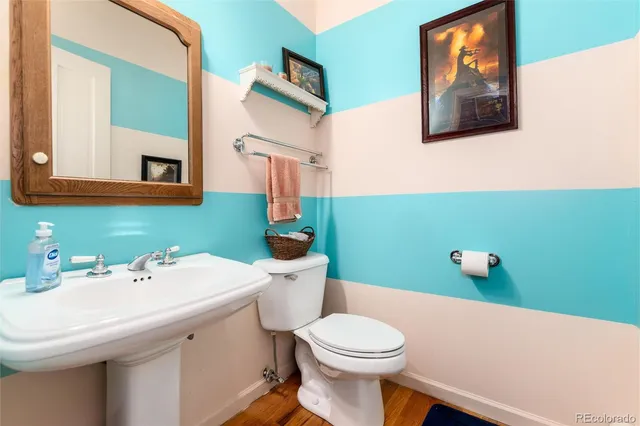 a bathroom with a sink mirror and toilet