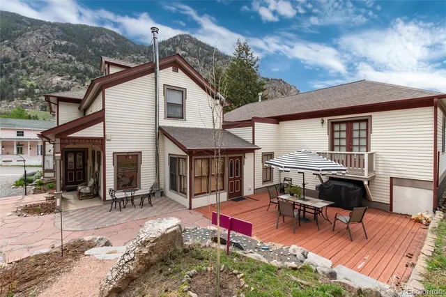 a view of a house with patio and a yard