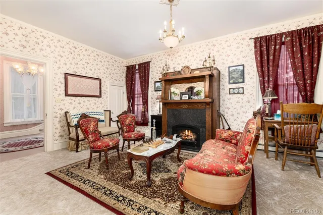 a living room with furniture a table and a fireplace