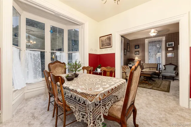 a view of a dining room with furniture and a window