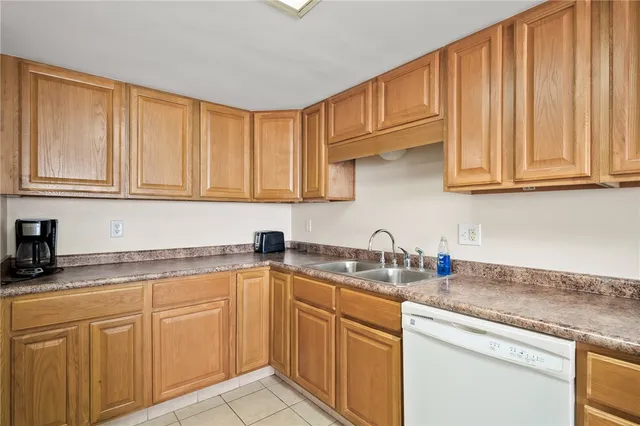 a view of a kitchen with granite countertop a stove a sink a dining table and chairs