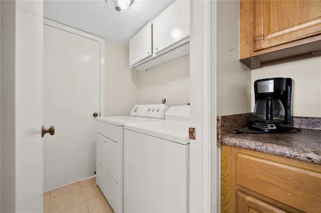 a spacious bedroom with a bed and a chandelier