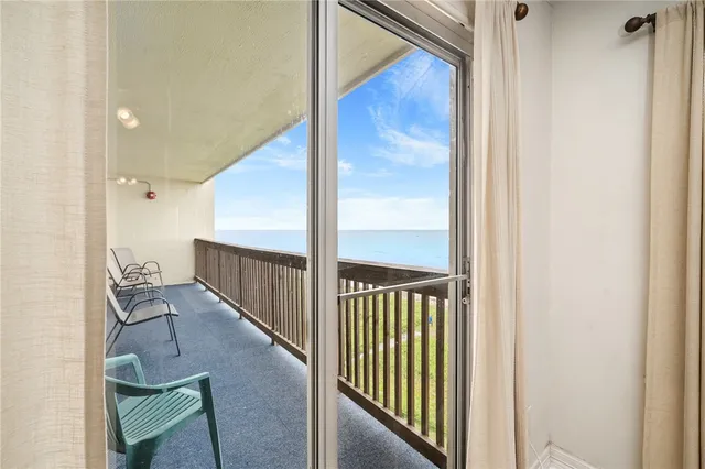 a spacious bedroom with a bed and a chandelier