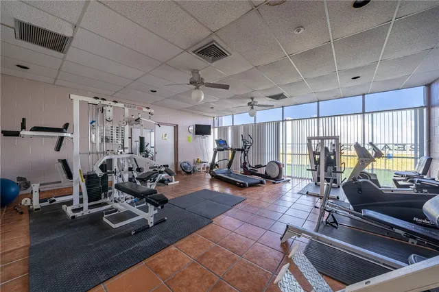 a view of a patio with a table and chairs under an umbrella