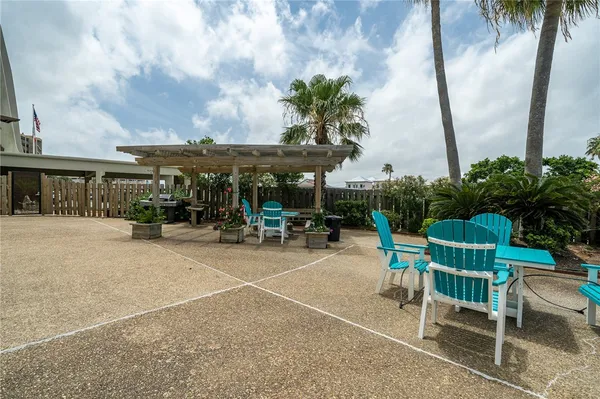 a view of a backyard with table and chairs