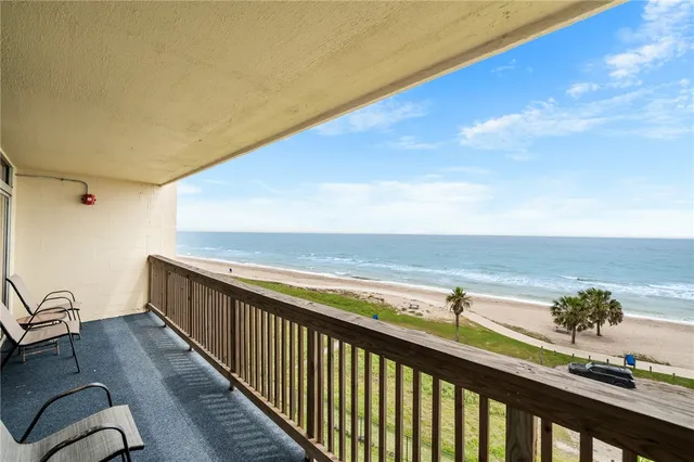 a kitchen with stainless steel appliances granite countertop a dining table and chairs