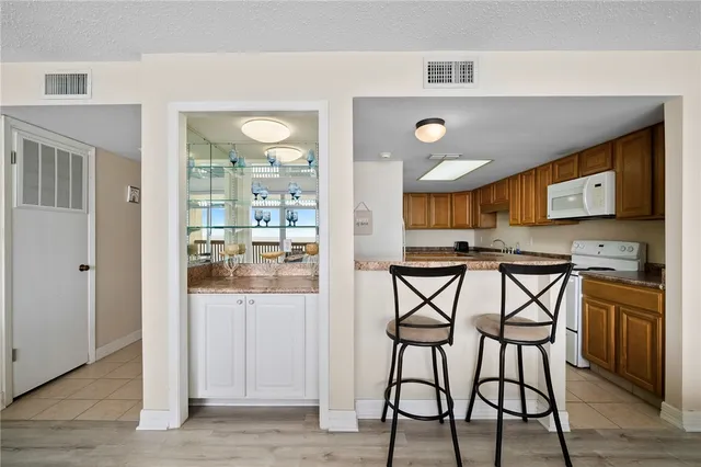 a kitchen with a sink a stove and cabinets