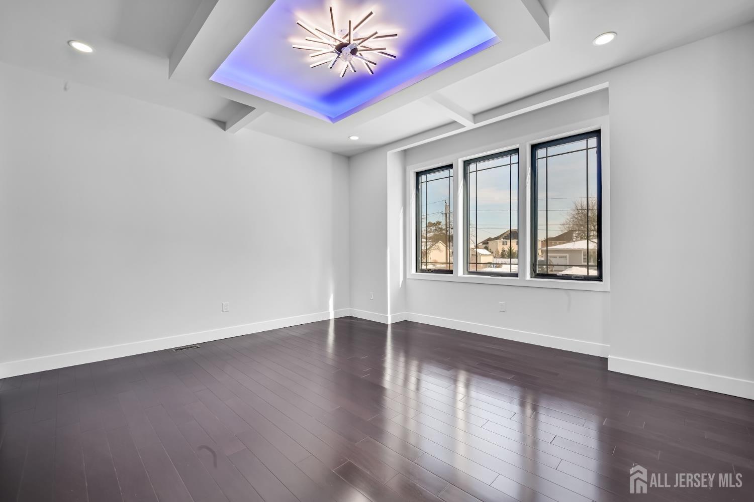 11 Williams Road Kendall Park, NJ 08824 - Photo 22 of 60 an empty room with wooden floor chandelier and windows