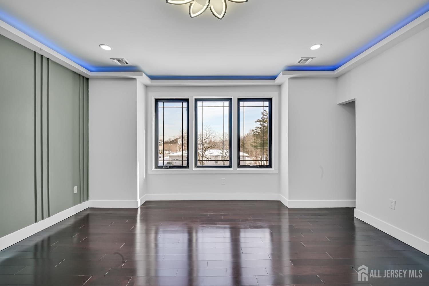 11 Williams Road Kendall Park, NJ 08824 - Photo 28 of 60 a view of an empty room with wooden floor and a window