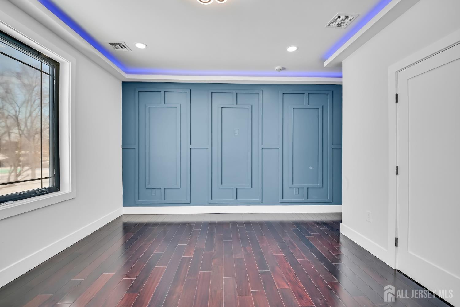 11 Williams Road Kendall Park, NJ 08824 - Photo 39 of 60 a view of an empty room with wooden floor and a window