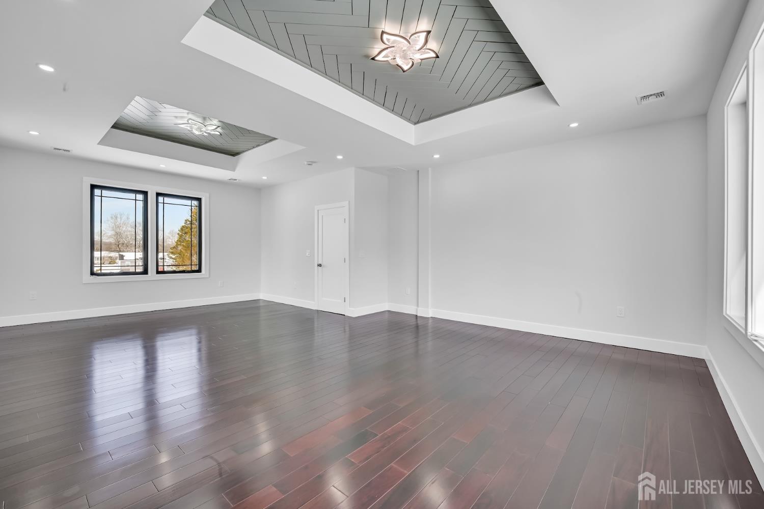 11 Williams Road Kendall Park, NJ 08824 - Photo 45 of 60 an empty room with wooden floor chandelier and windows